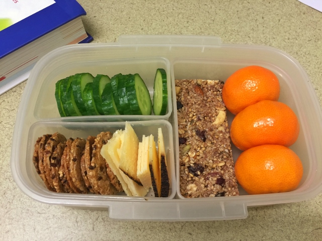 Mandarins, cucumber, cheese, crackers, granola bar bento lunch